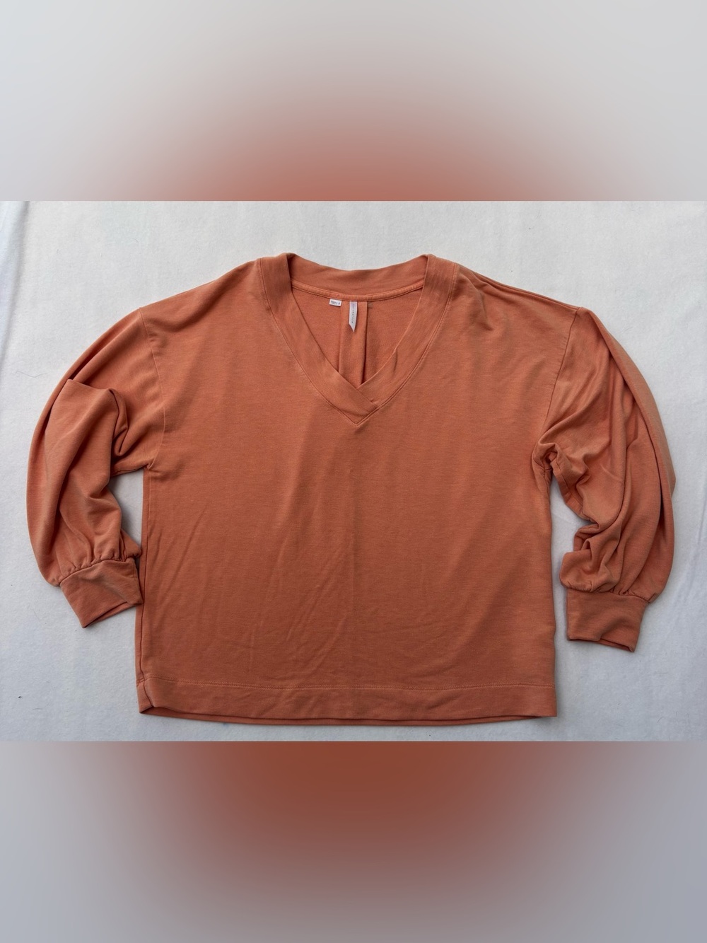 Travis Mathew Women's V-Neck Short Sleeve Top in Rusty Orange